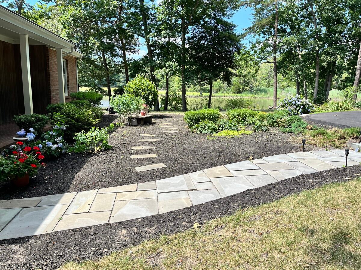 After — clean mulch bed with plantings by StarSeason
