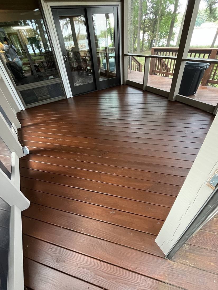 After — screened porch with brand new screening installed and a refinished floor